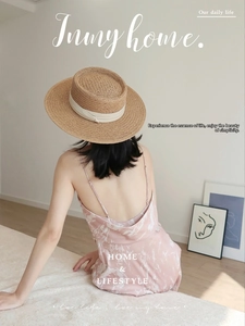 Flat top straw hat with wide white ribbon paired with a pink marble silk dress