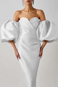 Detail of elegant white off-shoulder satin dress featuring dramatic puff lantern sleeves