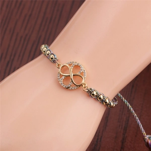 Gold infinity charm bracelet with sparkling crystals on a colorful braided cord strap