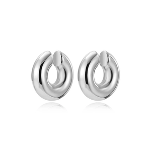 Macro view showing a pair of polished silver twist hoop earrings with mirror finish
