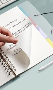 Detail of 30-hole loose leaf binder refill showing macaron color index dividers and ruled paper