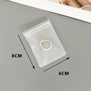 Detailed view of 8x6cm transparent EVA storage bag showing size for small jewelry items
