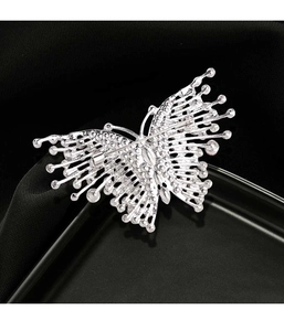 Detailed back view of a silver butterfly brooch with rhinestones on black fabric