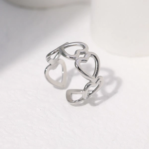 Detailed view of adjustable silver heart ring with open band and polished hollow-out design