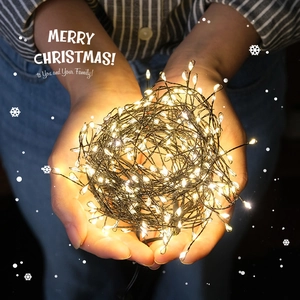 Warm white LED Christmas string lights held in hands for a cozy holiday atmosphere