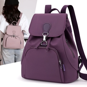 Detailed view of the drawstring closure and front zipper pocket on this nylon backpack
