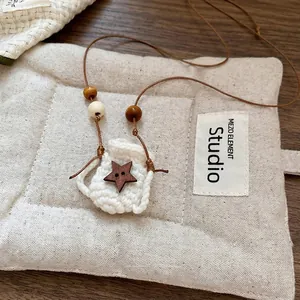 Handmade crochet pouch necklace with star wooden button and beaded strap in forest style