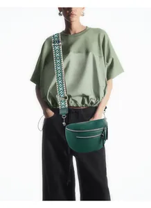 Close-up of litchi texture leather crossbody bag with ethnic style embroidered strap