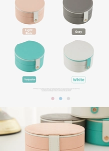 Detail view of semi-circular portable jewelry cases in pink, gray, cyan and white