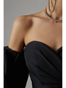 Detail of off-shoulder black party dress with layered rhinestone choker necklace