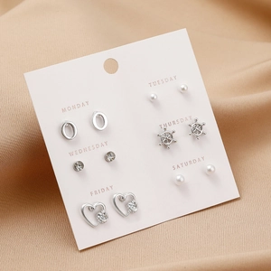 Detail view of 6-pair silver earring set with pearls and studs on weekday card