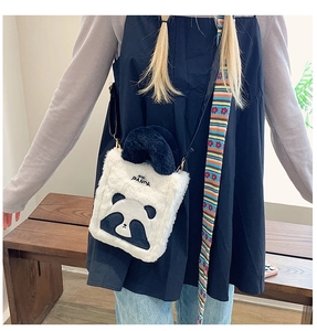 Detail of cute panda plush crossbody bag showing compact size and soft texture on a model