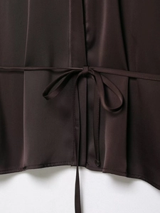 Detail view of deep brown satin shirt back with tie-up design and metal hook closure