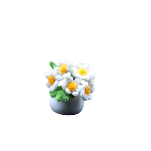 Handmade chenille stem white daisy plant in a white pot for desktop decoration