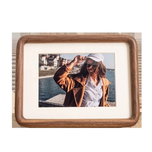 Solid walnut wood picture frame with rounded corners and elegant white matting insert