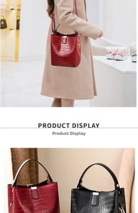 Detail view of crocodile-patterned bucket bags in red and black with metallic hardware