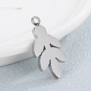 Polished silver leaf pendant crafted from stainless steel on a textured grey surface