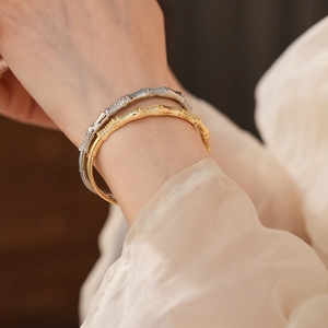 Close-up of gold and silver bamboo joint bracelets with shimmering pavé zircon details