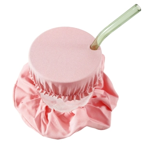 Pink scrunchie drink cover set with ruffled fabric cap and green glass straw detail