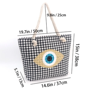 Detailed size chart for the woven houndstooth beach tote with evil eye design