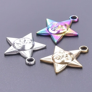 Detailed view of star pendants with crescent moon relief in gold, silver, and rainbow steel
