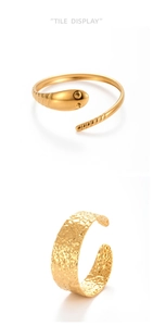Detail of gold snake-shaped ring and hammered texture open ring in 304 stainless steel
