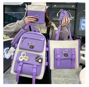 Detail of four-piece nylon student backpack set in purple and white including small pouches