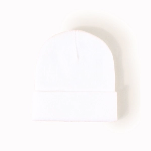 Close-up of white winter beanie showing fine knit texture and wide folded cuff