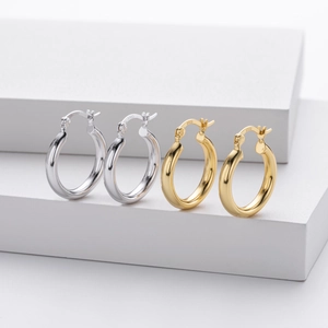 Close-up of S925 sterling silver hollow hoop earrings in gold and silver finishes