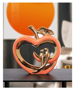 Detailed view of ceramic apple decor with golden birds and electroplated metal leaf accent