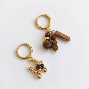 Gold plated tiger eye earrings with asymmetrical balloon dog and tassel accents