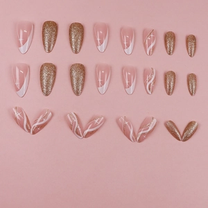 Pink almond press-on nails with golden glitter, white swirls and star patterns