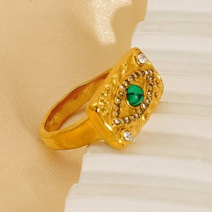 Vintage gold stainless steel malachite eye ring displayed on champagne silk background