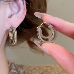 Detailed view of double layered 18k gold plated hoop earrings with brown matte chain link