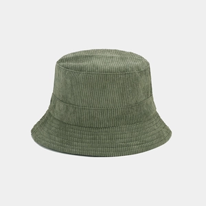 Detailed close-up of green corduroy texture on a minimalist reversible bucket hat