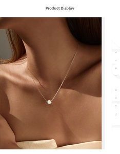 Macro detail of a minimalist gold S925 silver necklace with round synthetic opal stone
