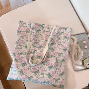 Flat lay of floral cotton tote bag with lavender roses and stylish hair accessories
