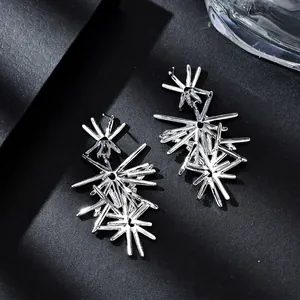 Minimalist silver starburst earrings with geometric irregular firework lines