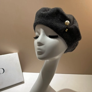French style dark grey wool beret with white pearls and gold buckle on a head model