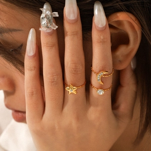 Stackable gold stainless steel star and moon zircon rings set worn by model