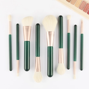 Detail of 10-piece makeup brush set with dark green handles and rose gold ferrules