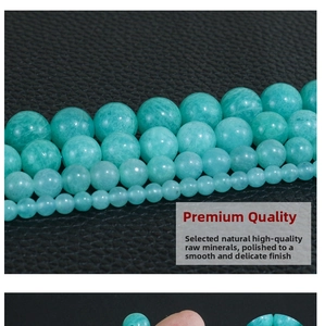 Macro shot of natural Amazonite round beads in various sizes on a black texture background