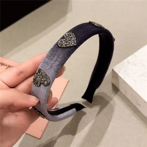 Detailed view of the purple velvet headband with sparkly black sequin heart patterns