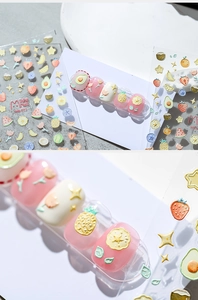 Detailed 3D embossed nail stickers featuring colorful strawberry and fruit patterns