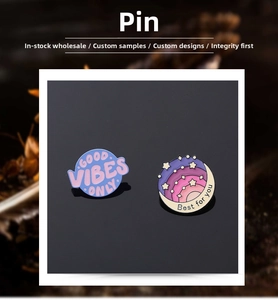 Detail view of round enamel pins featuring Good Vibes Only and Best For You starry night designs