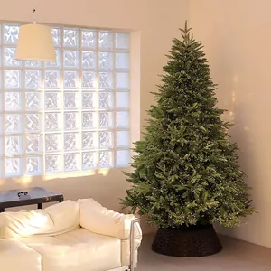 Artificial Christmas tree with LED lights and dark woven base in a warm living room