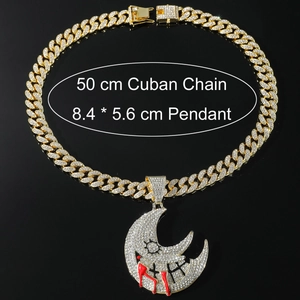 Macro detail of iced-out moon pendant with red enamel on a 50cm golden Cuban chain
