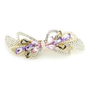 Elegant bow hair clip with purple and pink teardrop crystals and white pearls on white background