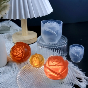 Macro detail of rose flower silicone molds and resin crafts under warm lamp lighting