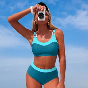 Detail view of sporty two-piece bikini featuring white ring accents and blue color blocking